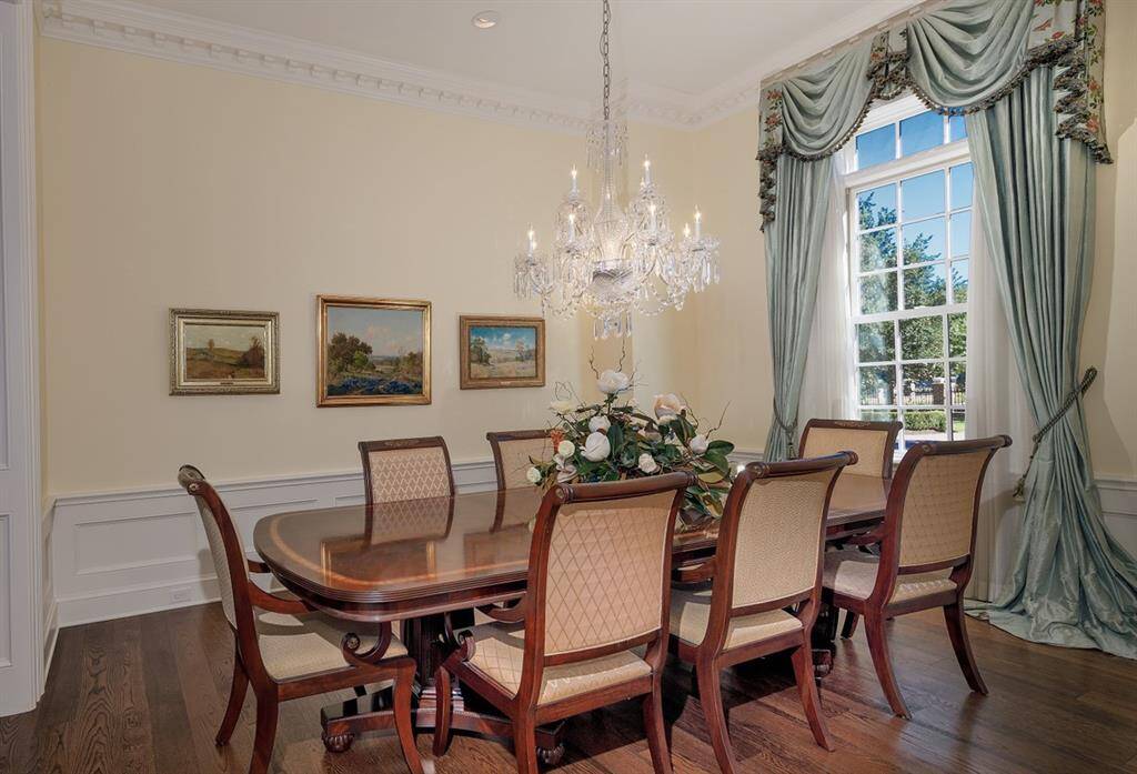 Formal dining room with wainscoting and White River dentil trim and paneled cased opening. Custom-made drapes made of silk and hand-painted in France inspired by Henrietta Spencer-Churchill "Georgian Style and Design".