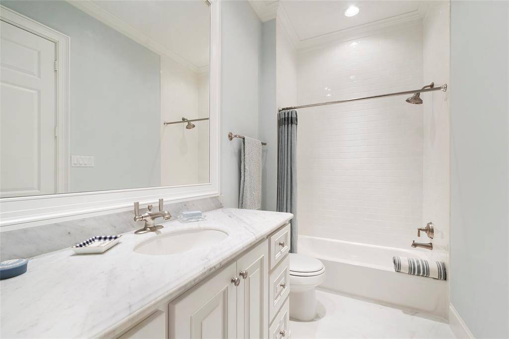 This is the shared full bath for the two secondary bedrooms on the first floor. Carrara Marble counter, built in medicine cabinet, subway tile tub/shower combo. Kohler fixtures.