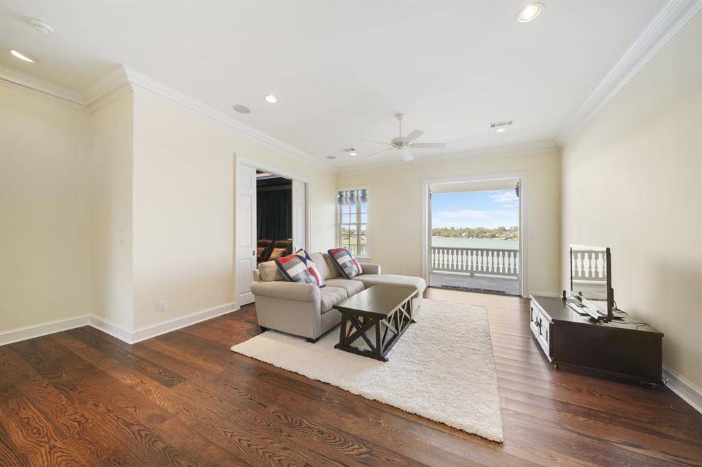Game room is centrally located on the second floor with French Doors that opens to a huge balcony with endless lake views. Entry to the media room is through the pocket doors to the left.
