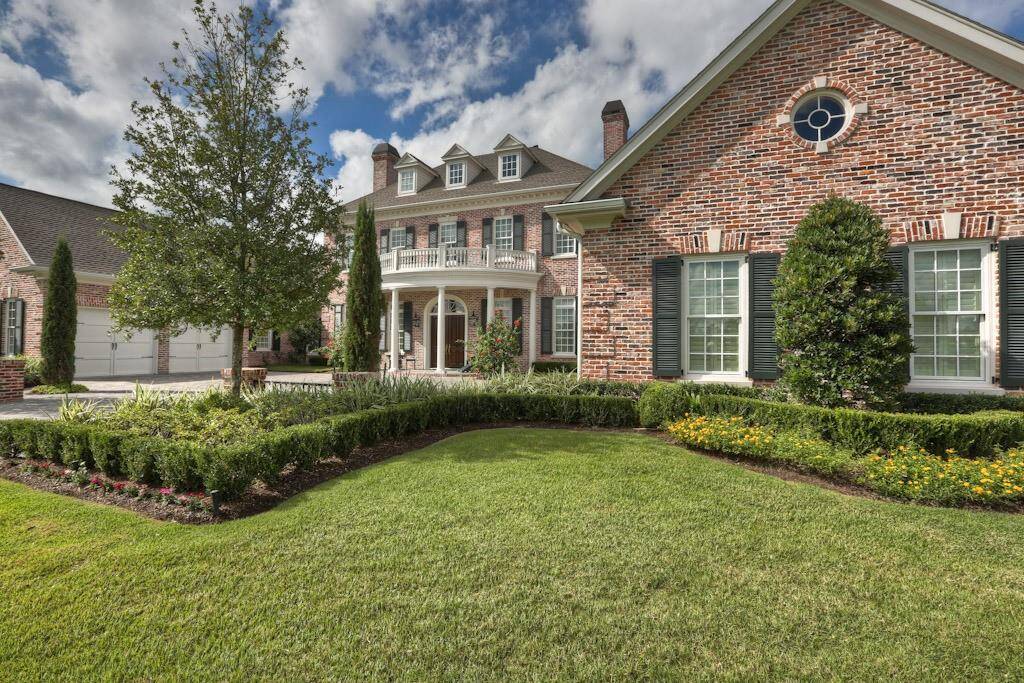 Classic English garden with Zoysia golf course grass complements the landscaping.
