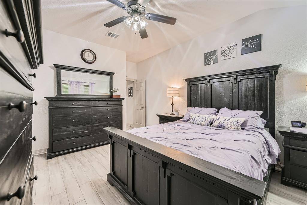 3106 Village Springs Ct. This primary  bedroom features a cozy atmosphere with warmth, while light flooring enhances the spacious feel.