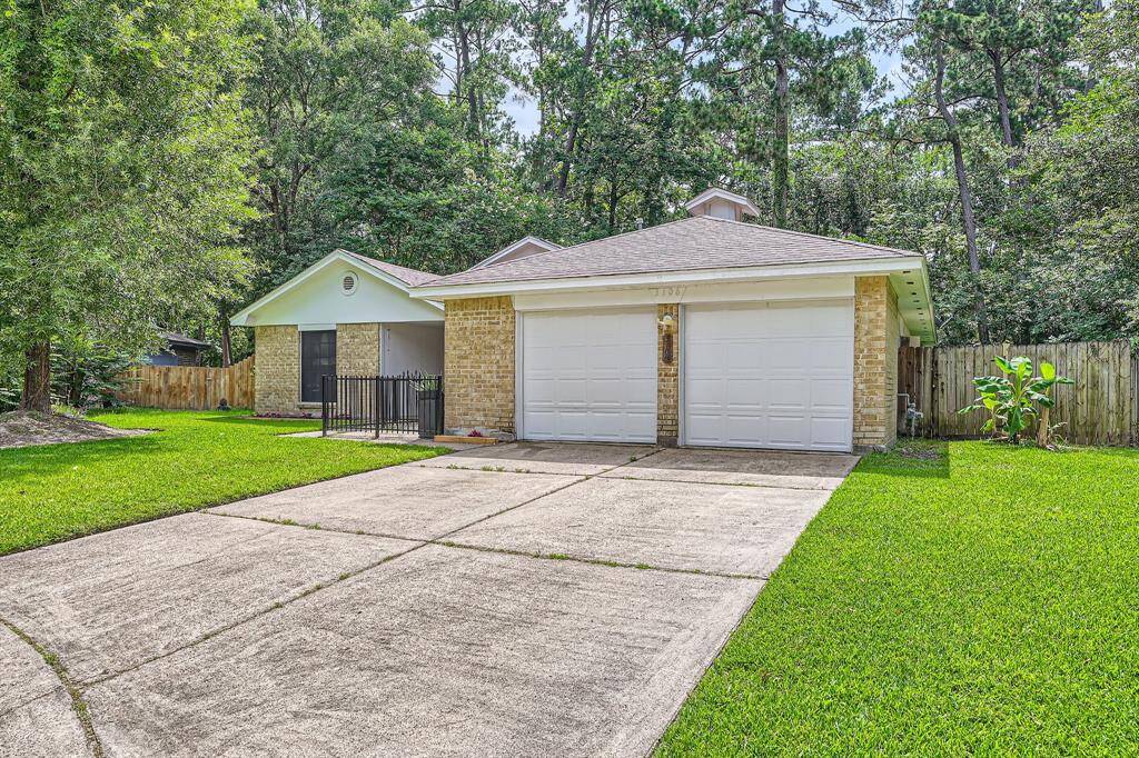3106 Village Springs CT. This charming home features a two-car garage and a spacious driveway. It's surrounded by lush greenery and mature trees, providing a serene, private atmosphere. The exterior is a combination of brick and siding, offering a classic and welcoming look.