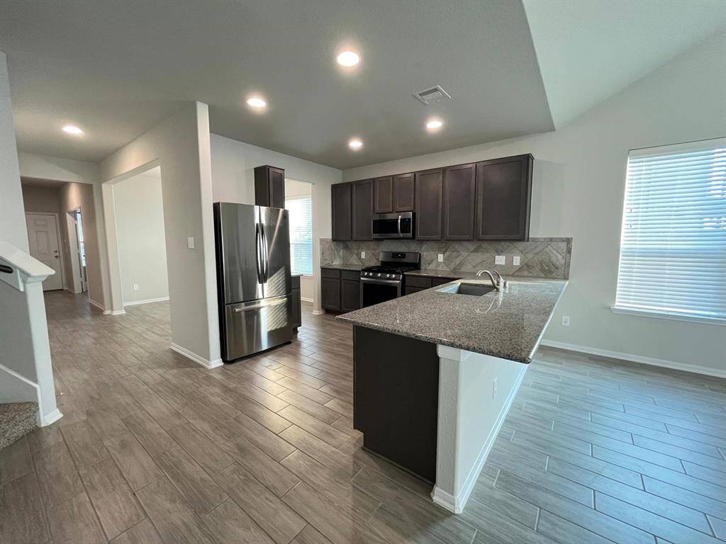 Another angle of the kitchen with a breakfast bar