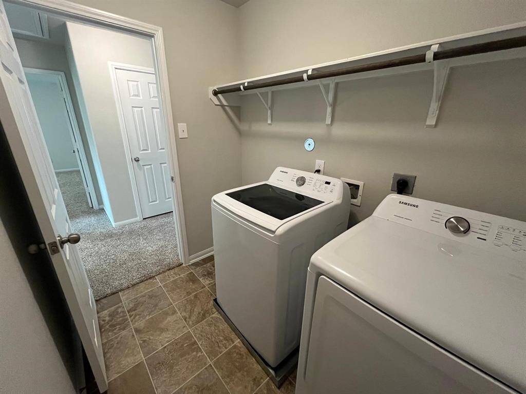 Awesome laundry room with washer and dryer included and built in shelved and drying rack