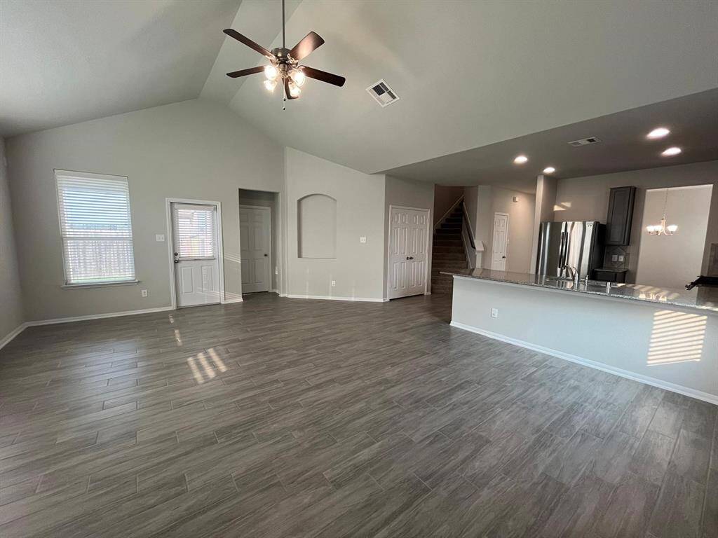 Another look at your living room. Notice the high ceilings, art nook, and exit to the patio