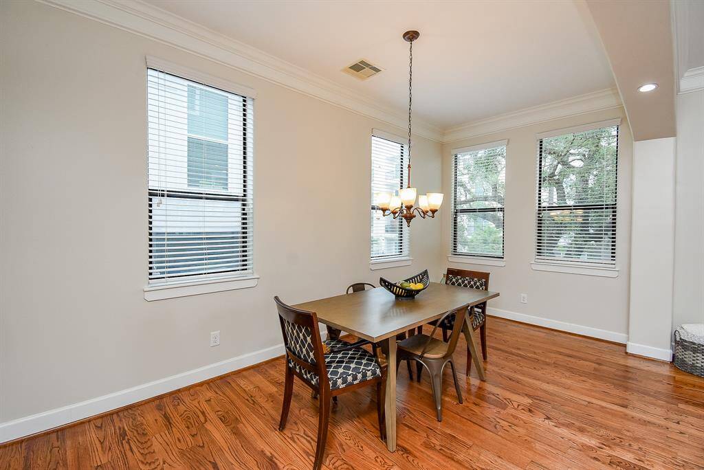 This dining area is flooded with light through the windows.