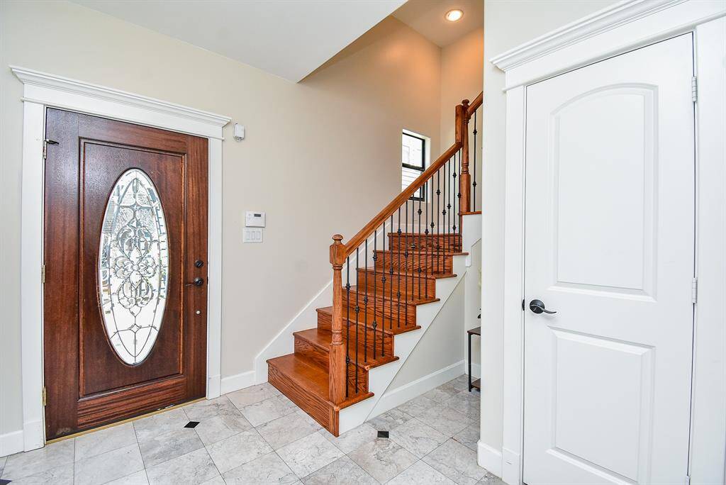 Upon entering, you are greeted with a decorative tile floor and tons of natural light.