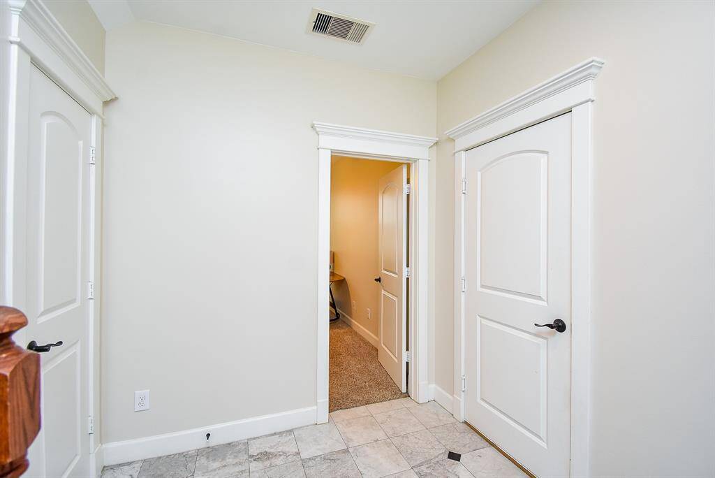 Oversized storage closet is located under the stairs.
