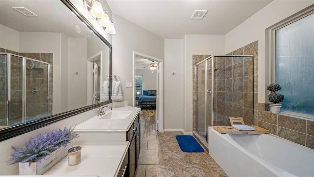 The primary bath offers dual vanities with plenty of storage. There is so much space to get ready here. Make getting ready a snap.