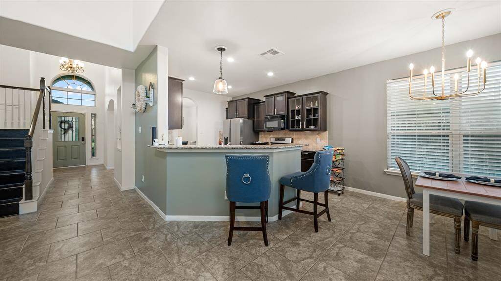 Whether it's for guests arriving for the first time or for the homeowners returning at the end of the day, stepping through this doorway is sure to evoke a sense of pride and joy. The living room, adjacent to the kitchen and breakfast area, offers a comfortable and inviting space for relaxation and socializing.