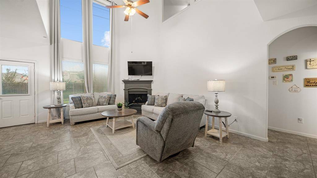 The wall of windows not only brings in abundant sunlight but also offers expansive views of the surrounding landscape, connecting the indoors with the outdoors in a seamless way.