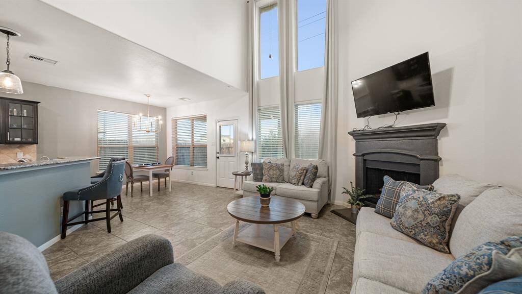 A cozy, gas-log fireplace adds an extra layer of warmth and ambiance to the living area, especially on chilly evenings.
