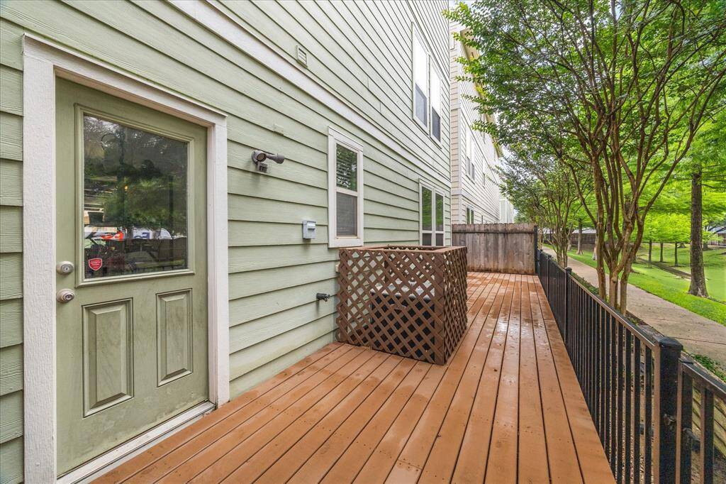 The gated wooden deck in the backyard provides direct access to the community green space and walking paths, perfect for outdoor relaxation and activities.