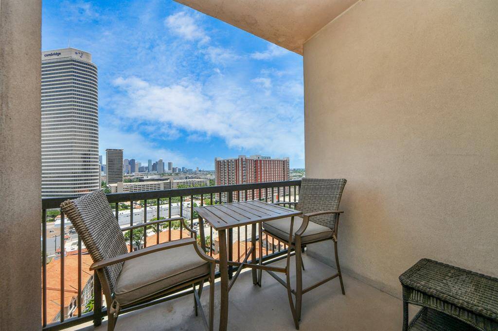 This photo shows a cozy balcony with a small table and two chairs, offering a stunning city skyline view. Perfect for enjoying morning coffee or evening relaxation.