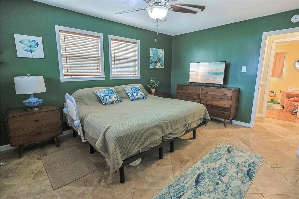 Retreat to your coastal getaway right at the end of the hall in this primary bedroom.