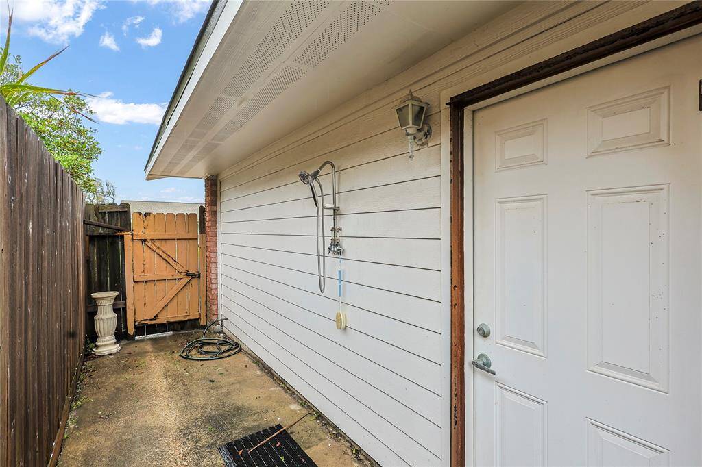 An outdoor shower is conveniently located just outside the fenced yard area for those long days at the beach.