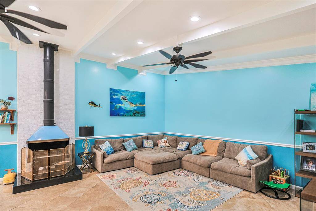 This spacious living area is bright and comfortable with soaring vaulted and beamed ceilings and a charming pipe chimney fireplace- perfectly cozy for movie nights with the family.