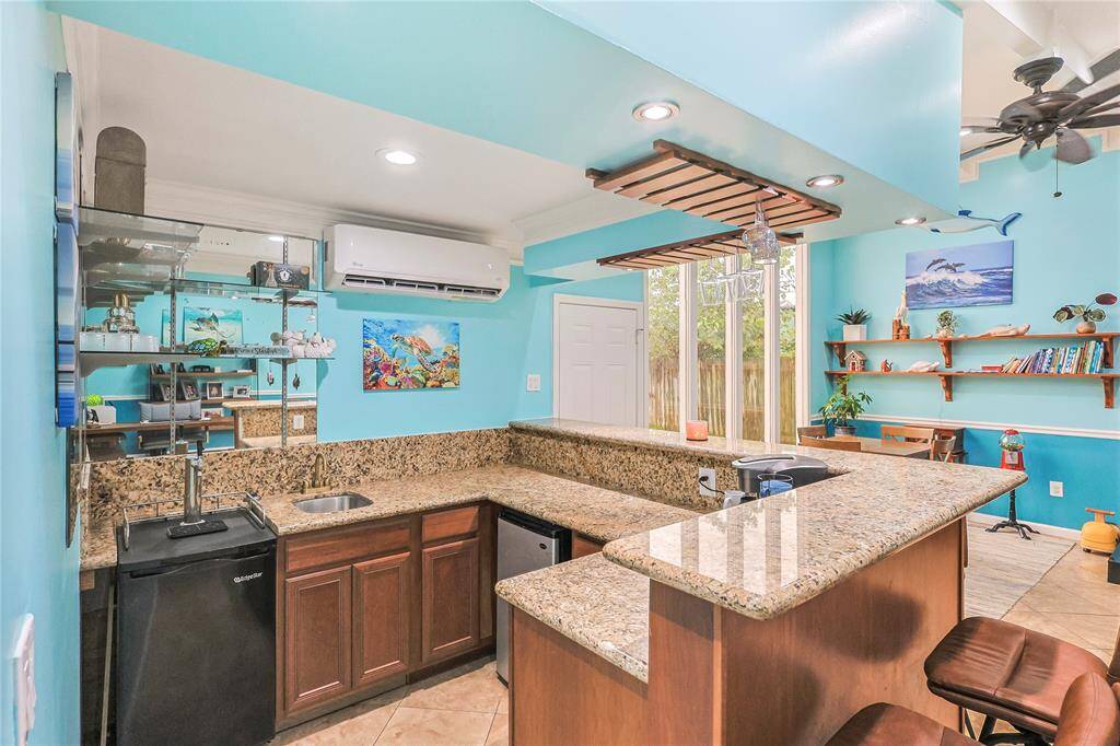 Get a closer look at the bar which is perfect to host your friends and family this summer. The extra AC mini split is there to supplement the central AC.  The light and bright party room is one you must see!