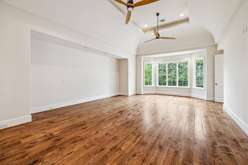The primary suite is a true retreat with his and hers baths, high ceilings and lovevly natural light.