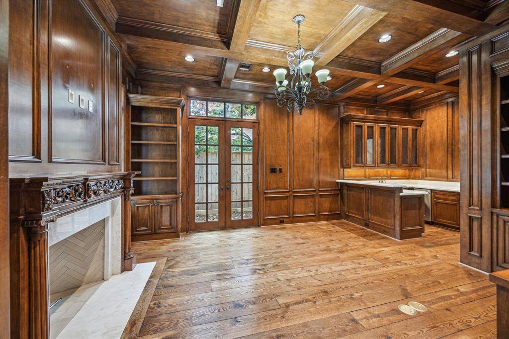 The paneled study and bar have a rich wood and cozy fireplace.