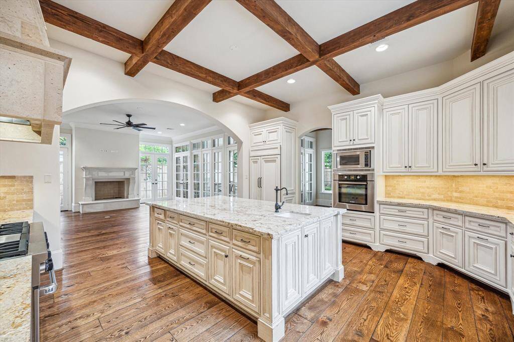 This dream kitchen features top of the line appliances, gleaming hardwoods, beautiful marble and tons of natural light.