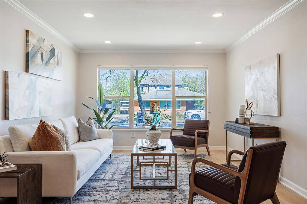 Warm and inviting living space in the front of the home features large picture window and recessed lights