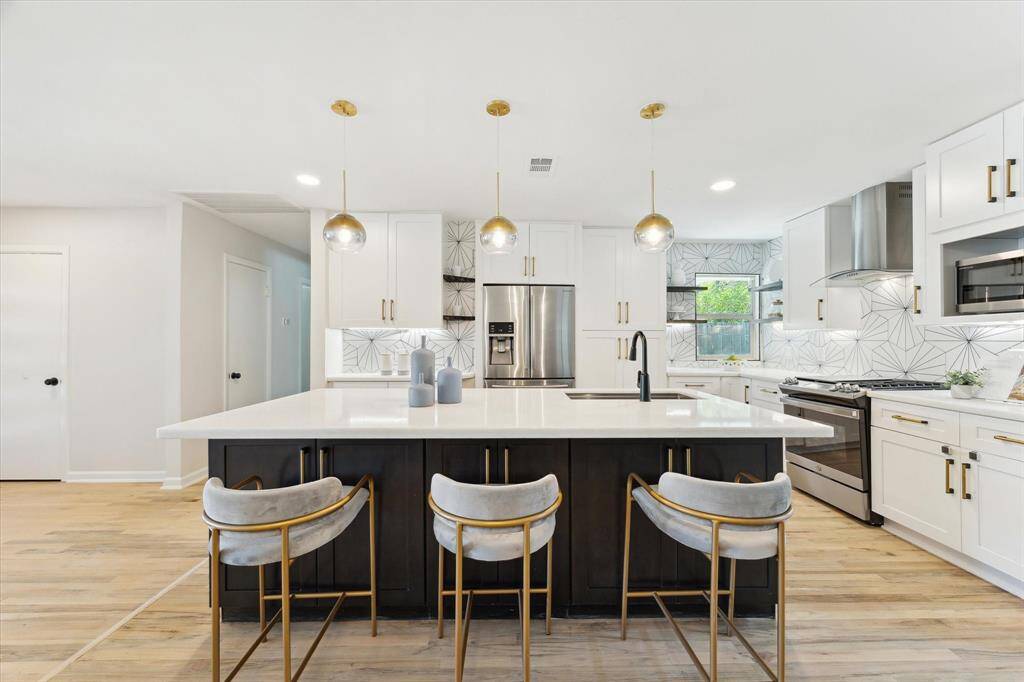 Kitchen was remodeled in 2022 and features custom maple cabinets with soft close doors, marble counter tops under cabinet lighting and designer lighting