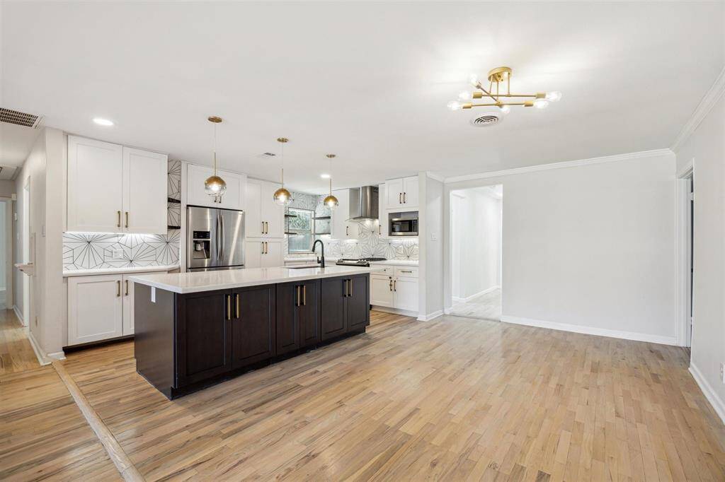 Designer lighting and refinished hardwood floors