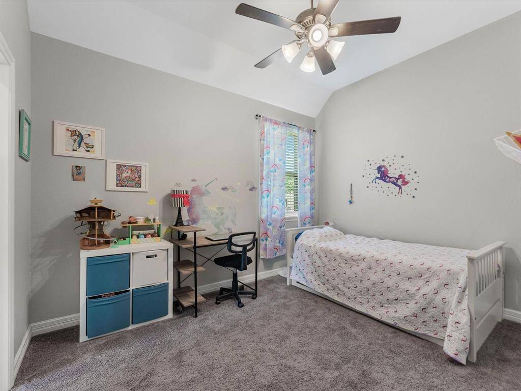 Inviting secondary bedroom with thoughtful design, offering plenty of room for rest, study, or relaxation.