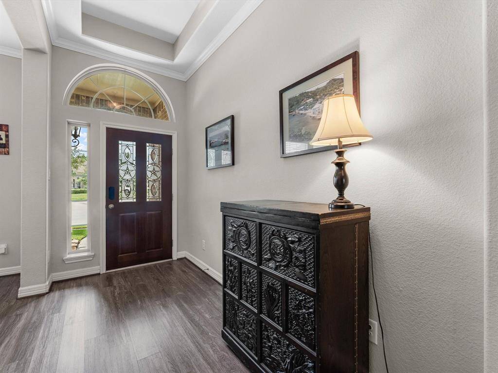 Welcoming entryway featuring a a beautiful front door, natural lighting, and stylish details.