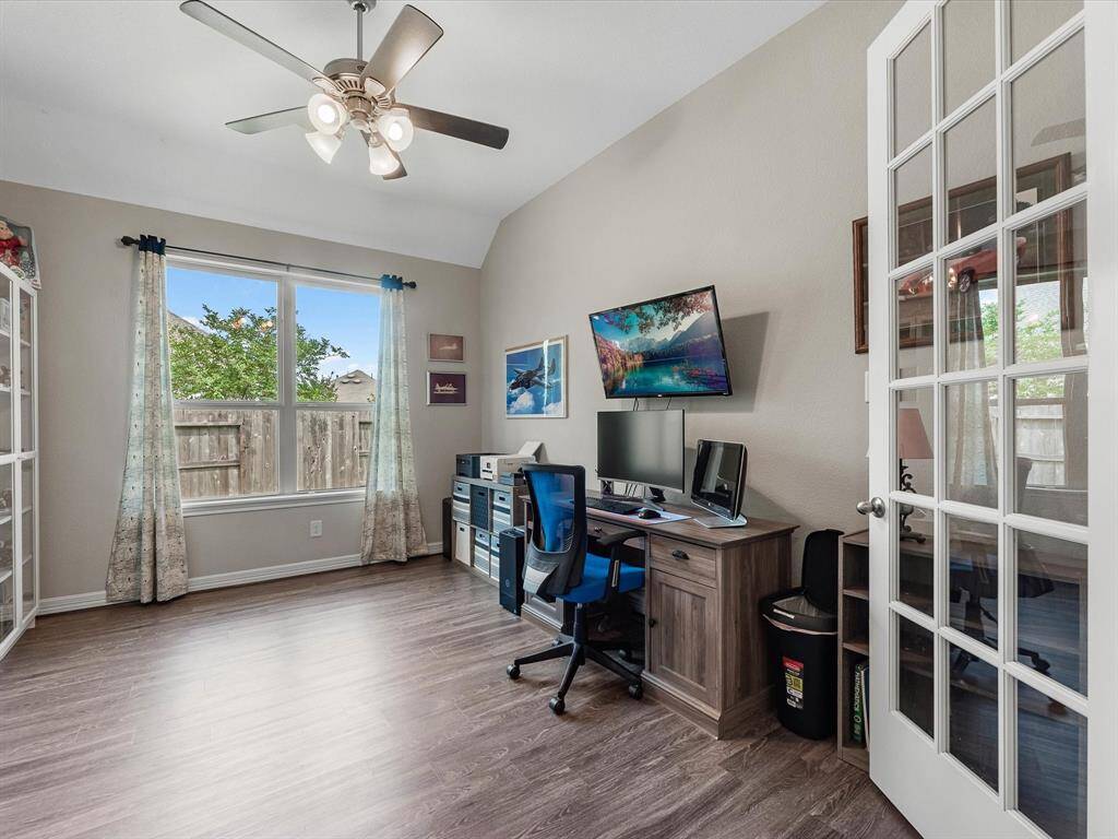 The home office features French doors, beautiful floors, large windows that give a fresh feel, this space promotes focus and creativity.