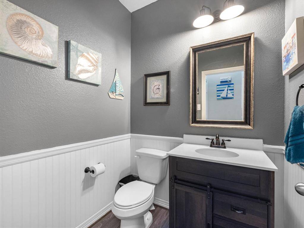 This charming home features a beautifully appointed half bath adjacent to the family room, perfect for welcoming guests and adding convenience to your daily life.
