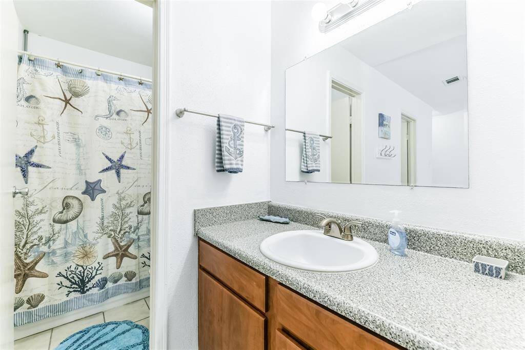 Primary bathroom consists of a single sink and a tub/shower combo.