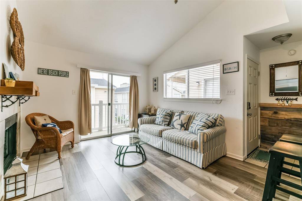 This second-floor unit offers a balcony off the living room and primary bedroom.