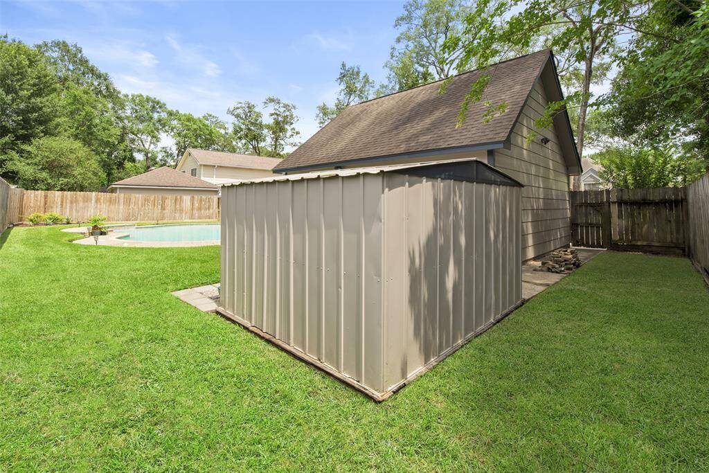 Storage shed behind garage