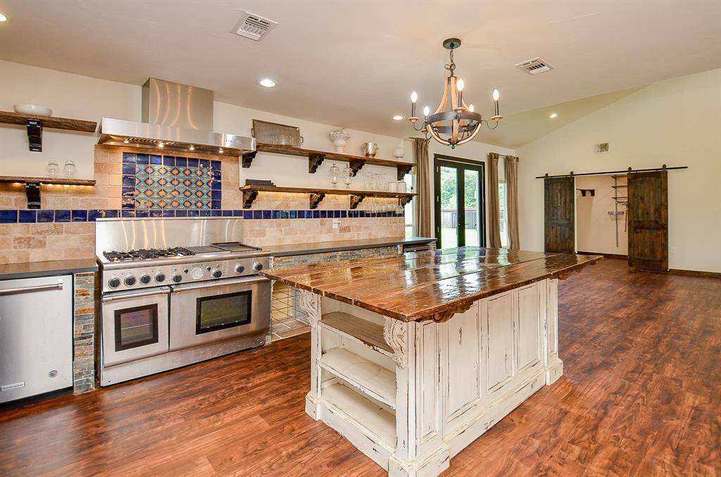 Corian countertops allow for plenty of prep space and custom wood shelving for storage