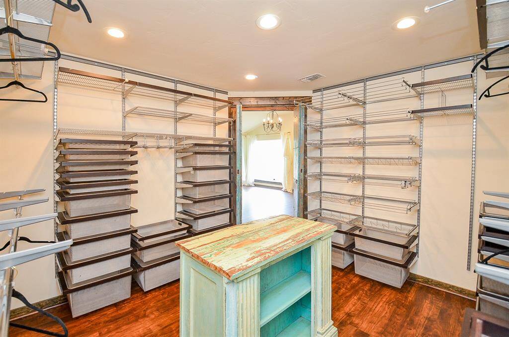 Primary closet with tons of drawer and hanging space