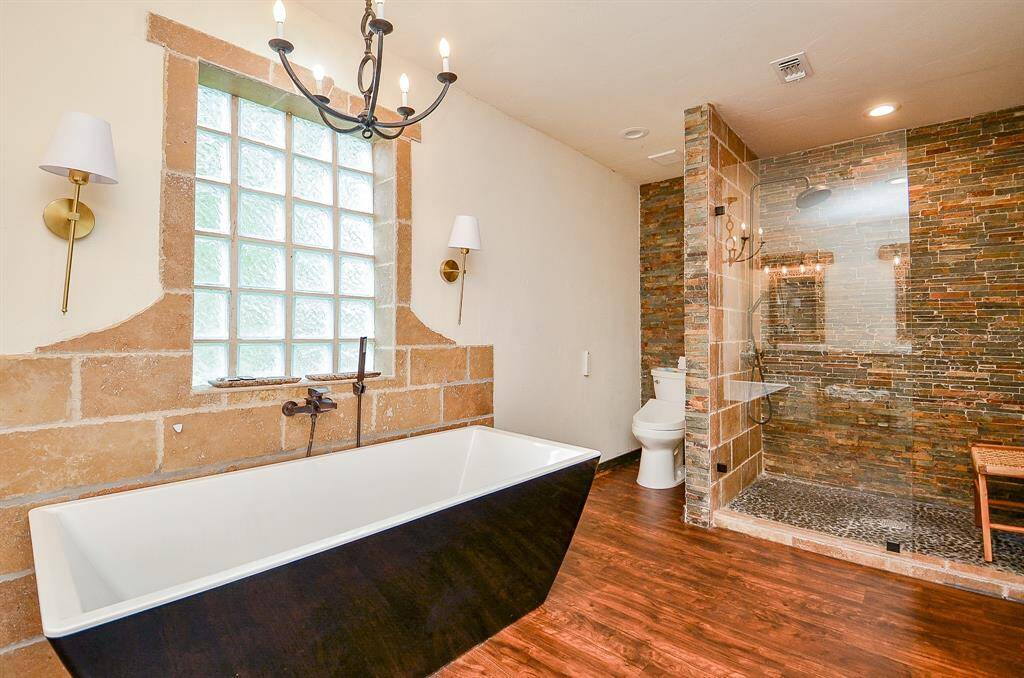 Primary bath features soaking tub, very large custom shower and double vanities