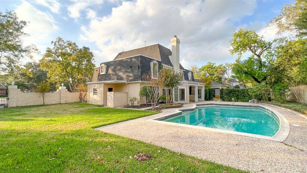 Step into your own private paradise in this impeccable backyard, where spaciousness, lush landscaping, and entertainment seamlessly blend. The large pool is adjacent to a covered patio, making this home great for entertaining!