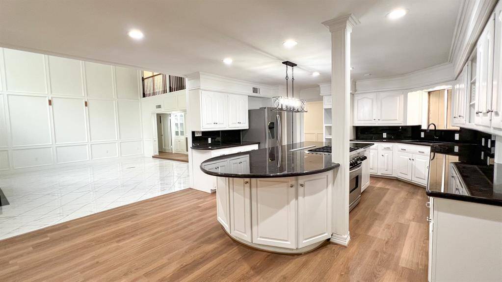 Designed with both form and function in mind, the kitchen maintains the sleek monochromatic scheme and open concept of the home, with thoughtful design touches in every corner.