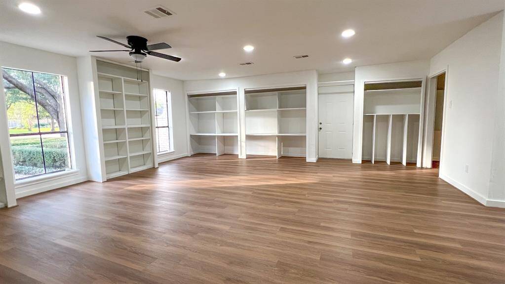 This impressive flex room serves as a seamless extension of the home's living areas. Custom built-ins provide abundant storage space, making this room ideal for a game room or study.
