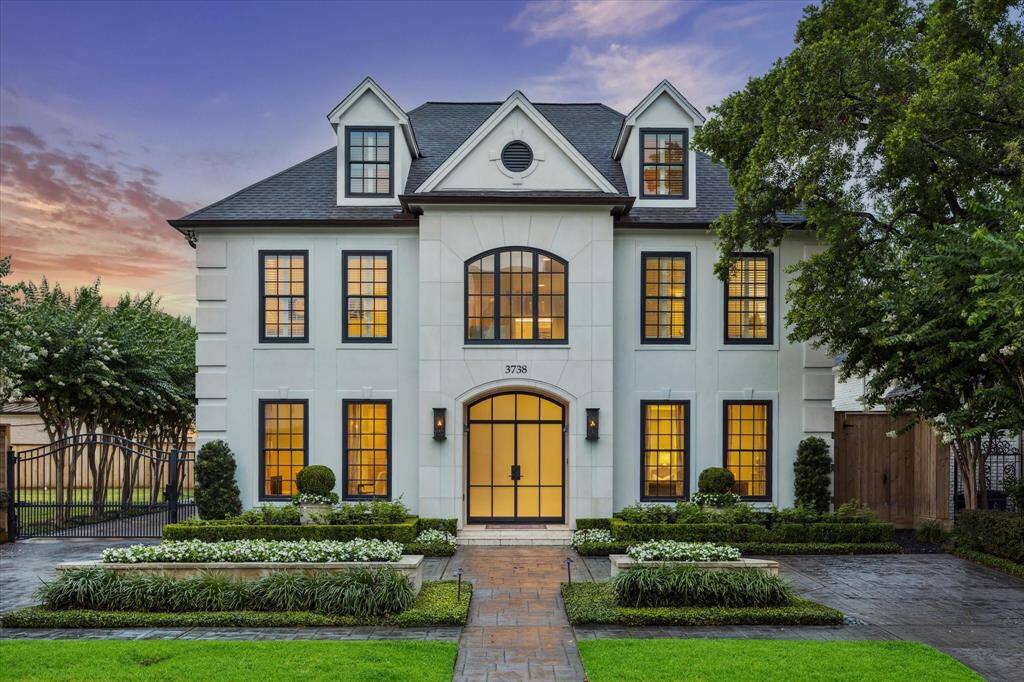 Located in Royden Oaks, this 2014 redesigned home by Ed Eubanks is situated on an expansive double lot - 17,880 sq. ft (app dist). The traditional 3 story front facade is appointed with an impressive double door entry flanked by handsome lanterns, two front facade sides with near floor to ceiling mullioned windows and finished stately coins The second floor mimics the same design - with the third floor dormer set into a high pitched roofline. Finely manicured shrubbery surrounds a brick driveway/walkway.