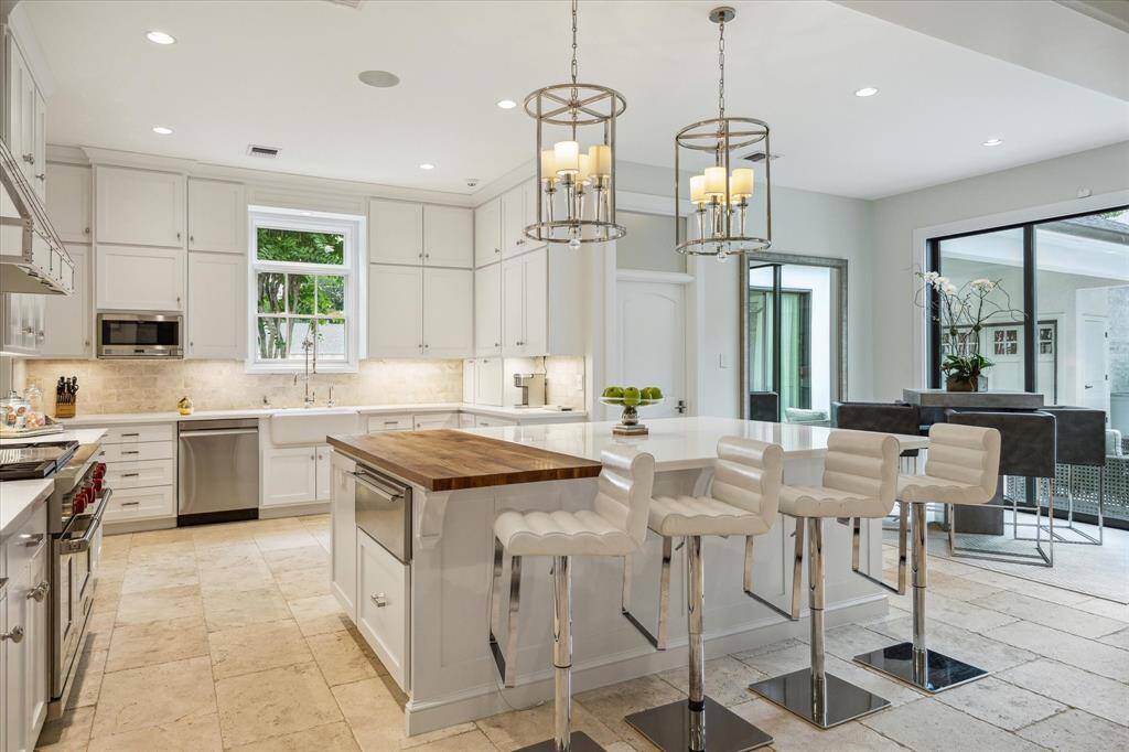 The KITCHEN (18 X 114) includes a generously sized Center Island (102" X 68") with an innovative/practical marble/butcher block counter, cabinets/drawers underneath, Breakfast Bar seating, two lanterns. Also notice the plentiful supply of cabinet storage and counter space afforded with the well planned space created for the chef!