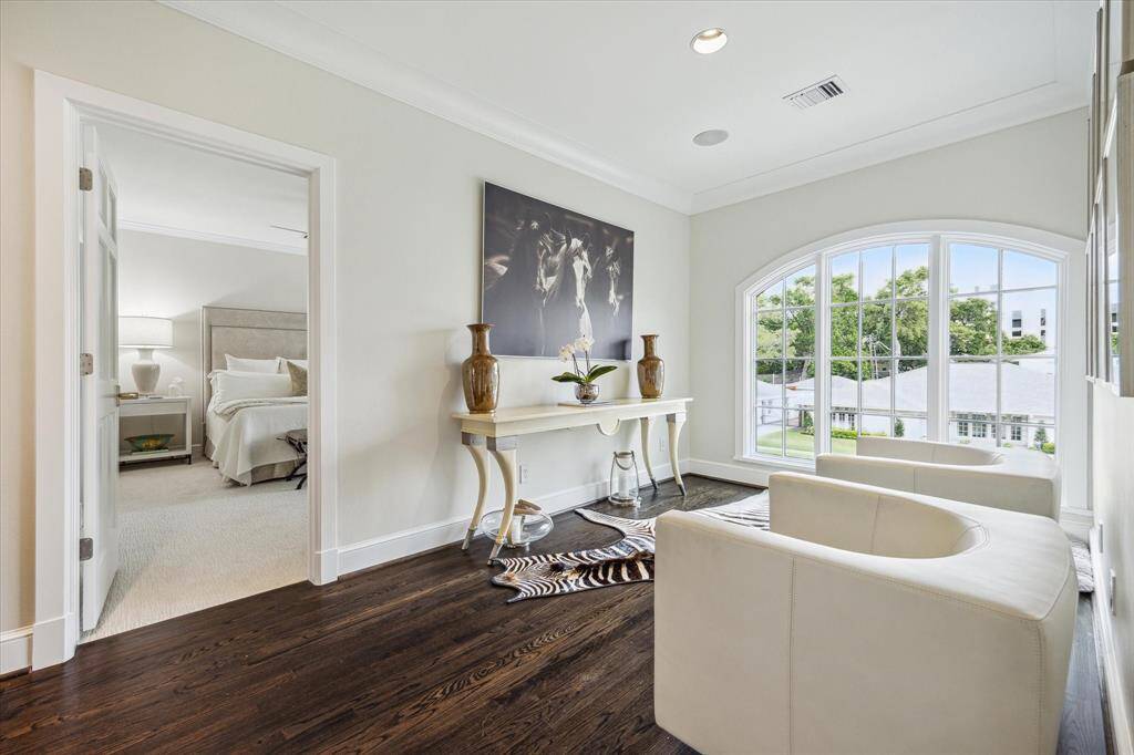 The second floor LANDING enjoys a quiet nook (11 X 8)  with hardwood flooring, arched mullioned 3-panel window, ceiling speakers, recessed lighting, crown/base molding.