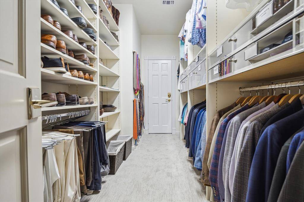 WALK-CLOSET in the HOME OFFICE - featuring clear front display storage, built-in shelving/hanging compartments and door to Cedar Closet.