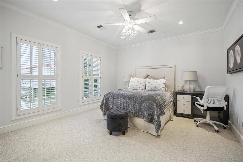 BEDROOM #3 features carpeted flooring, ceiling fan, recessed lighting, two shuttered windows, crown/base molding, closet with mirrored dual door entry/hanging compartments/shelving, En Suite Bath.