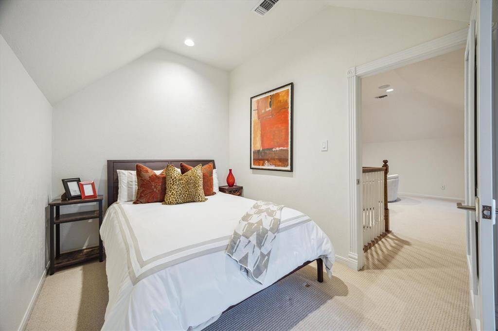 Third Floor BEDROOM (12 X 15) includes carpeted flooring, pitched ceiling, dormer window with plantation shutters, recessed lighting, base molding and adjacent Bath.