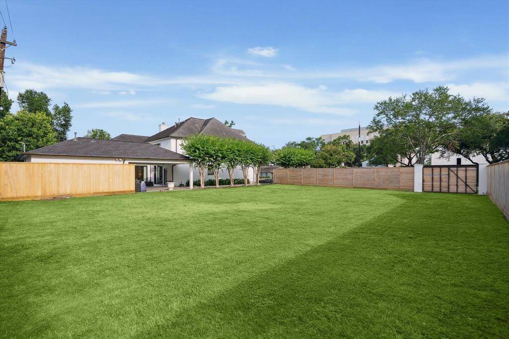 From the back side of the vacant lot looking toward the driveway and porte-cochere.  So many opportunities for the lot usage!!