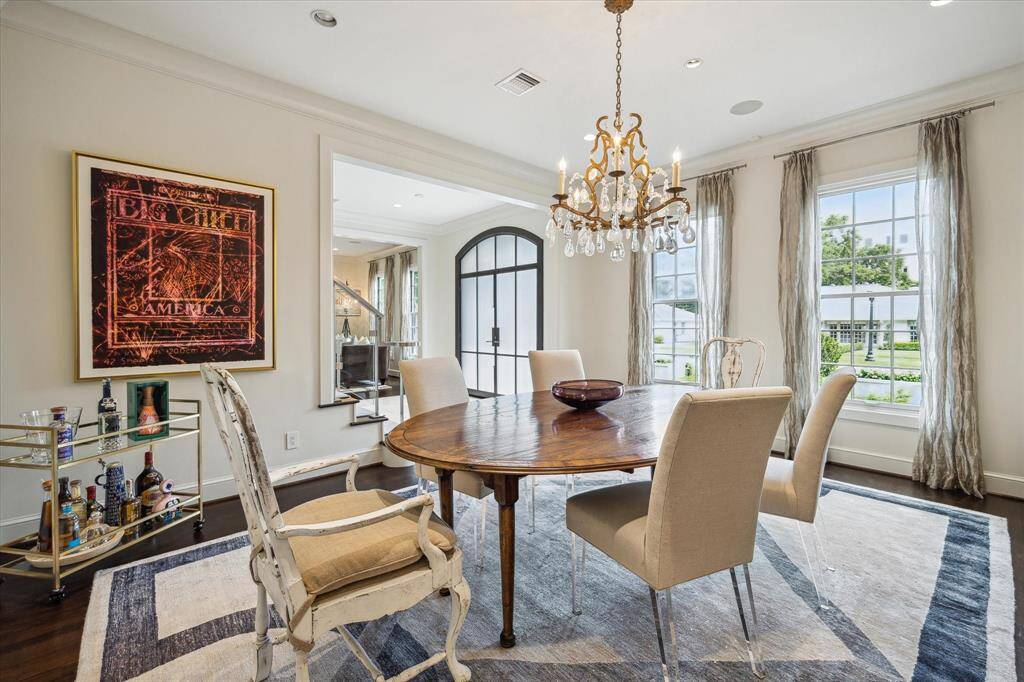 View from the back corner of the Dining Room showing the room's expansive opening from the Front Entry and the great amount of natural light filtering through th oversized windows - an easy transition from one room to another.