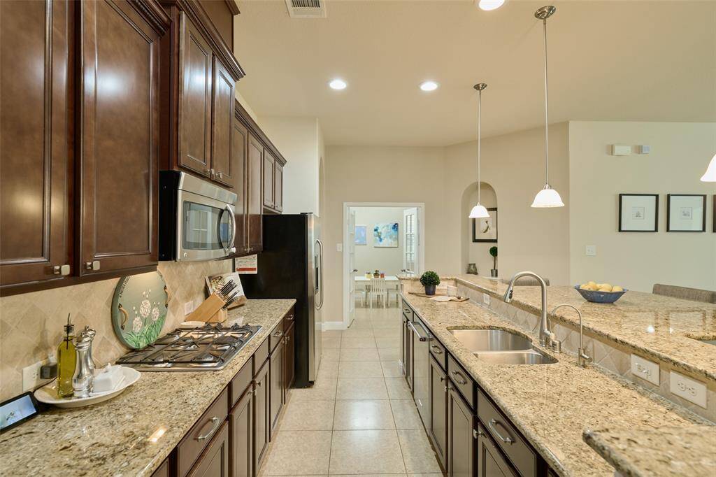 Super functional laundry room with a utility sink and plenty of cabinets for storage.